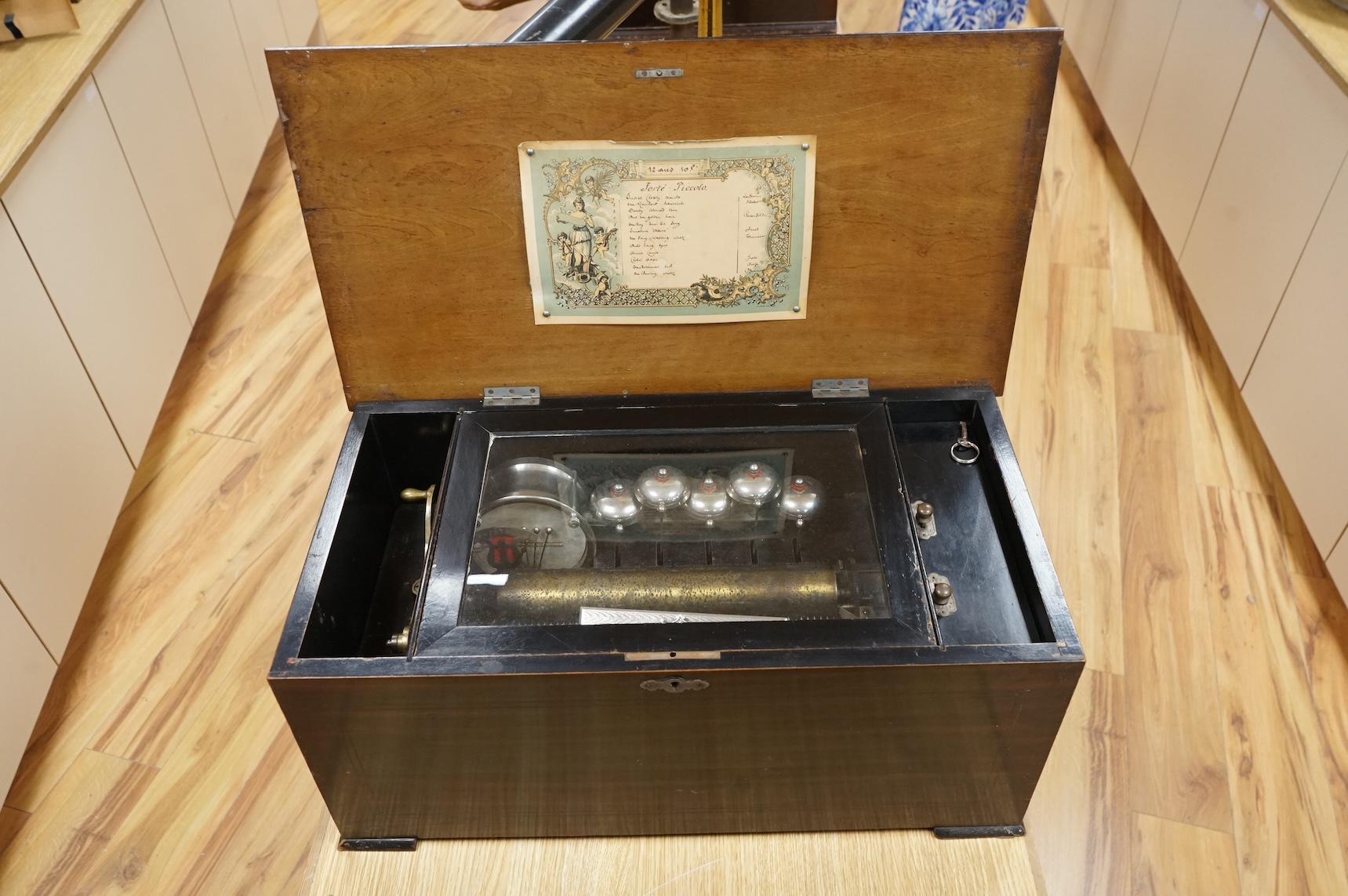 A late 19th century Swiss music box in a rosewood and ebonised case, playing twelve airs on a 52 tooth comb, five bells and a drum, 60cm wide, 27cm high, 32.5cm deep.